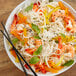 A white bowl of Rice Stick Noodles with shrimp and vegetables.