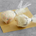 Individually wrapped white Chalet Desserts cake pops.