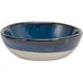 A Front of the House indigo and white porcelain ramekin with a black rim.