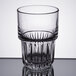 A close-up of a Libbey Everest cooler glass with a curved rim and patterned design.