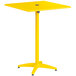 A yellow square Lancaster Table & Seating bar height table with a black circle on top.