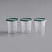 Three clear Vigor polycarbonate containers with green lids.