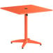 An orange Lancaster Table & Seating dining height table with a metal base.