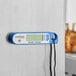 A blue AvaTemp digital thermometer with a white border and magnet.