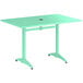 A Lancaster Table & Seating dining height outdoor table with a sea foam green top and metal legs.