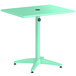 A seafoam green Lancaster Table & Seating dining table with a black circle on top.