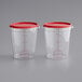 Two clear plastic Vigor food storage containers with red lids.