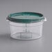 A Vigor clear plastic food storage container with a green lid.
