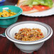 A bowl of beans and peppers in a GET Diamond Cambridge melamine bowl on a table.