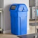A Toter blue plastic trash can with square lid.