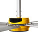A yellow and silver Big Ass Fans ceiling fan with metal blades.