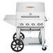 A silver Crown Verity natural gas barbecue grill on a cart with wheels.