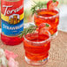 A glass of strawberry and rosemary margarita made with Torani Strawberry Fruit Syrup.
