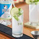 A glass of Polar lime club soda with lime slices and mint leaves.