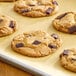 A close-up of a chocolate chip cookie with Enjoy Life Semi-Sweet Vegan Mega Chocolate Chunks on it.