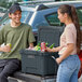 A man and woman standing next to a CaterGator outdoor cooler.