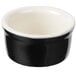 A black and eggshell white ceramic Tuxton ramekin.