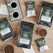 Crown Beverages Organic Breakfast Blend Whole Bean Coffee bags on a table with coffee beans.
