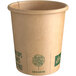 A New Roots brown paper hot cup with green text.
