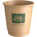 A New Roots brown paper hot cup with a green logo.