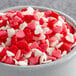 A bowl filled with red and white Regal Mini heart sprinkles.