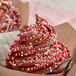 A chocolate frosted cupcake with Valentine's Day Nonpareil Mix sprinkles.