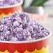 A bowl of purple popcorn with Great Western Grape Popcorn Glaze.