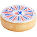 A round cheese wheel with a circular blue and red label.