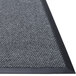 A gray and black Guardian EliteGuard customizable Berber carpet entrance mat with a black border and rubber backing.