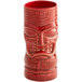A close-up of a red ceramic Libbey Tiki Tumbler with a face on it.