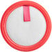 A round white sponge filter with a red circle and a pink ribbon.