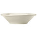 A close-up of a Libbey Porcelana cream white fruit bowl with a rolled edge.