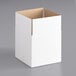 A white box with a cut out top and brown edges.