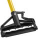 A black handle on a yellow Lavex mop pole.