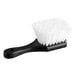 A close-up of a black utility scrub brush with white bristles.