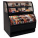 A black Structural Concepts Harmony refrigerated dual service merchandiser with food and drinks on a counter.