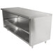 A stainless steel Advance Tabco work table with fixed mid shelf on a counter.