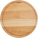 A Boska round beech wood serving board on a table.