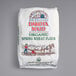 A bag of Dakota Maid organic whole wheat flour with a man and horse drawn on it.