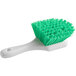 A close-up of a Lavex green utility brush with a white handle.