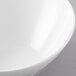 A white San Michele melamine bowl with a slanted design on a gray surface.