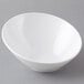 A white GET slanted melamine bowl on a gray surface.