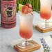 A glass of pink Top Hat Provisions Ruby Go Wild Paloma with a slice of grapefruit on the rim.