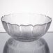 A clear glass Arcoroc Fleur bowl on a table.