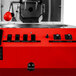 A red Primo SENTINEL-Xr20 coffee roaster with black switches and knobs.