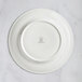 A white RAK Porcelain flat plate with an embossed design.