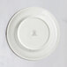 A white RAK Porcelain flat plate with an embossed crown on the rim.