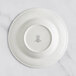 A white RAK Porcelain deep plate with an embossed floral design.