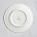 A white RAK Porcelain saucer with a circular design.
