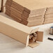 A stack of Lavex Kraft corrugated shipping boxes.